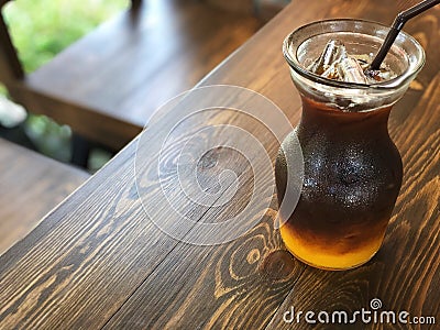 Black coffee mixed with honey bee and Orange juice Stock Photo