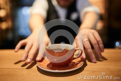 Black coffee in orange cup on brown wooden table background. Stock Photo