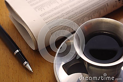 Black Coffee, Pen and Newspaper Stock Photo