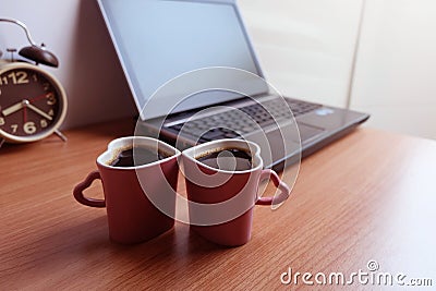 Black coffee in two cups heart shape and laptop computer Stock Photo