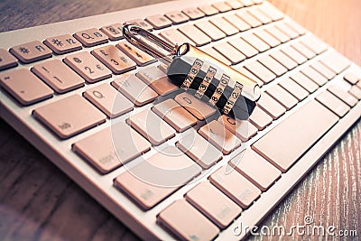 Black Combination Lock On A White Keyboard - Secure Computer Login Concept Stock Photo