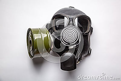 Black command gas mask with a filter lies on a table on a white background. Horizontal orientation Stock Photo