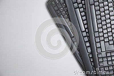 Black computer keyboards on grey background Stock Photo