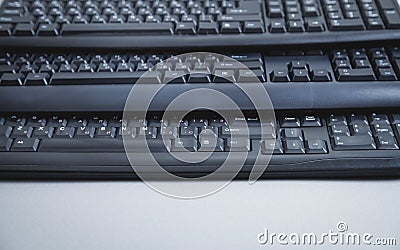 Black computer keyboards on grey background Stock Photo