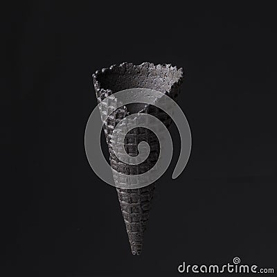 black cone for ice cream on black background. Creative, minimalistic concept Stock Photo