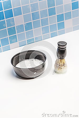 A black container with foam soap and a barber brush to apply foam to the face Stock Photo