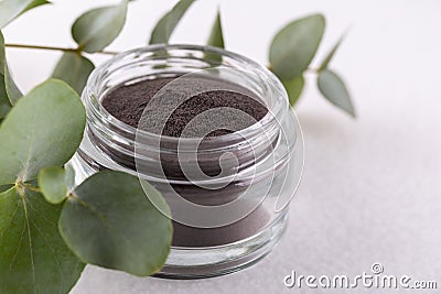 Black cosmetic clay powder Stock Photo