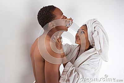 Black Couple Wrapped In Bath Towel Brushing Teeth Royalty Free Stock