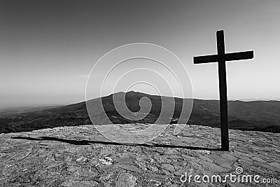 Black cross with mountain in background Stock Photo