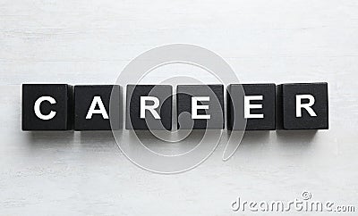 Black cubes with word CAREER on wooden background, flat lay Stock Photo