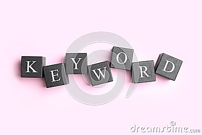 Black cubes with word KEYWORD on pink background Stock Photo