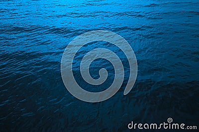 Black dark deep sea blue abstract background. Wavy water surface. Color gradient. Night. Reflection. Moon light. Ripple wave Stock Photo