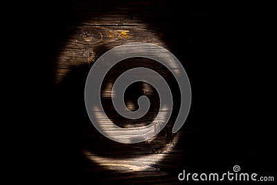 Black or dark laughing pumpkin Halloween Jack-o`-lantern of shadow on a dark wooden background. Jackolantern Stock Photo