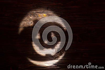 Black or dark laughing pumpkin Halloween Jack-o'-lantern of shadow on a dark wooden background. Jackolantern Stock Photo