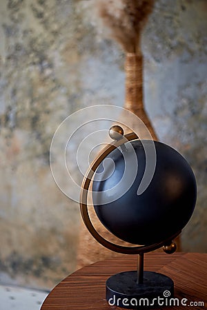 Black decorative globe. The subject of the interior in the style of minimalism.An interesting solution for home and Stock Photo