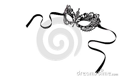 Black delicate lace mask on a white background. Black metal carnival mask. Stock Photo