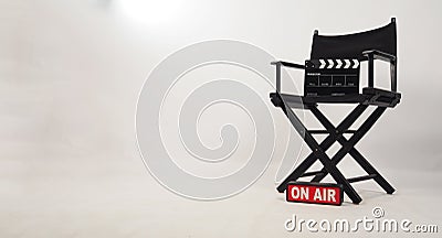 Black director chair and black clapper board on the chair and on air box on white background Stock Photo