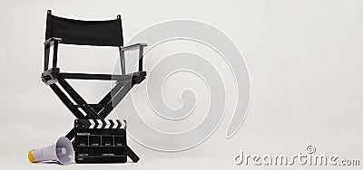 Black director chair and Clapper board with yellow megaphone on white background Stock Photo