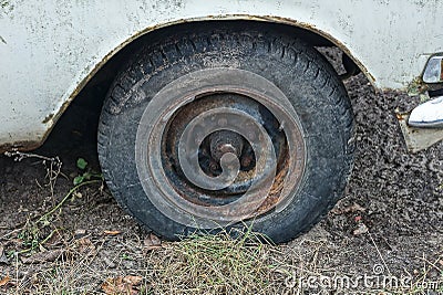 black dirty wheel on a white car on the street Stock Photo