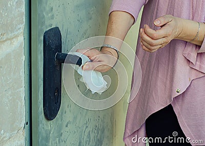 A woman suffering germophobia presses dirty door handle Stock Photo