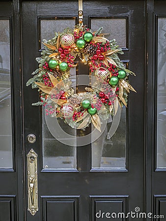 Christmas wreath on building door Stock Photo