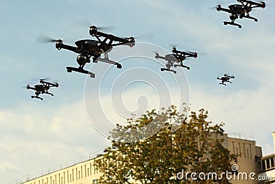 Black drone army flying in the city Stock Photo