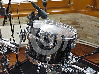 Black drum kit, cables and microphones closeup Stock Photo