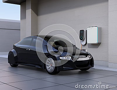 Black electric car charging at home charging station Stock Photo