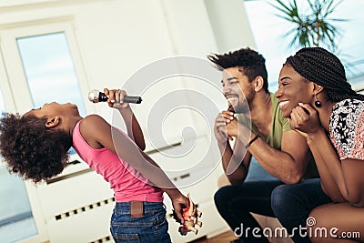 Black family enjoy singing karaoke Stock Photo