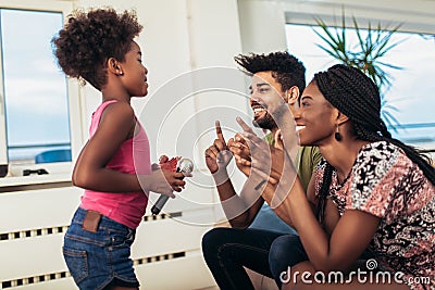 Black family enjoy singing karaoke Stock Photo