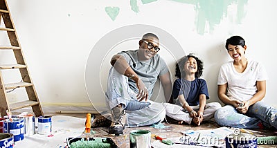 Black family painting house wall Stock Photo