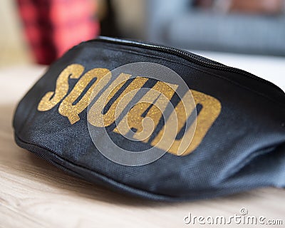 Black Fanny Pack with Gold Squad Lettering Stock Photo