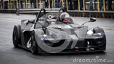 A black fast sports car drives on a racing circuit in Brno, Czech Republic. Editorial Stock Photo