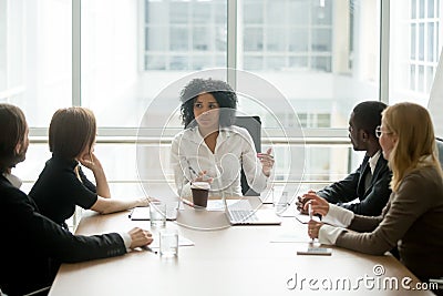 Black female boss leading corporate meeting talking to diverse b Stock Photo