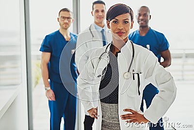 Black female doctor leading medical team Stock Photo