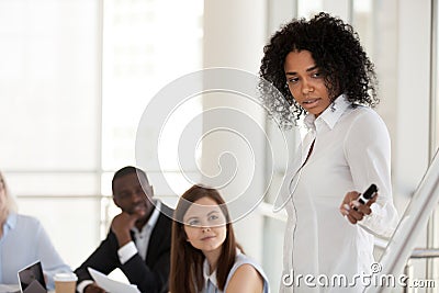 Black female mentor make presentation on flipchart training empl Stock Photo