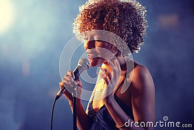 Black female Singer Performing on stage Stock Photo