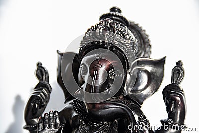 Black figurine of Lord Ganesh with white background Stock Photo