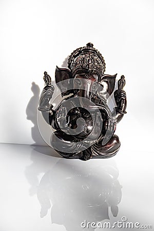 Black figurine of Lord Ganesh with white background Stock Photo