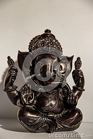 Black figurine of Lord Ganesh with white background Stock Photo