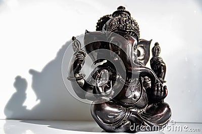 Black figurine of Lord Ganesh with white background Stock Photo