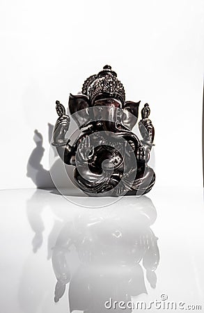 Black figurine of Lord Ganesh with white background Stock Photo