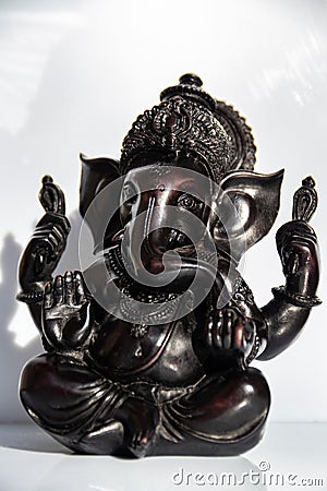 Black figurine of Lord Ganesh with white background Stock Photo