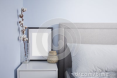 Black flame poster mockup in cozy scandinavian bedroom with blue walls. Scandinavian bedroom interior Stock Photo