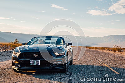 Black Ford Mustang GT convertible is parked by the infinite long road Editorial Stock Photo