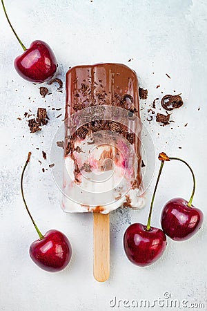 Black Forest chocolate fudge popsicles with roasted cherries and coconut cream. Vegan creamy ice pops, nicecream, fudgesicles. Stock Photo