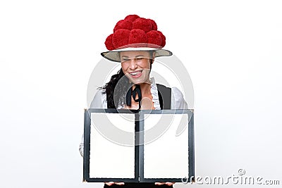 Black Forest waitress who winks mischievously and sticks out her tongue Stock Photo