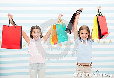 Black friday coming. Kids girls children with packages after shopping day. Girls friends happy carry paper bags. Best Stock Photo