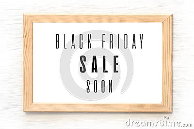 Black Friday sale poster in wooden frame hanging on the wall. Vector illustration Vector Illustration