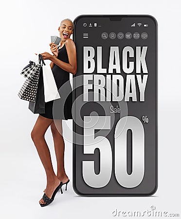 Black Friday shopping online, black woman very happy for purchases made showing credit cards and shopper bags. Isolated on white Stock Photo